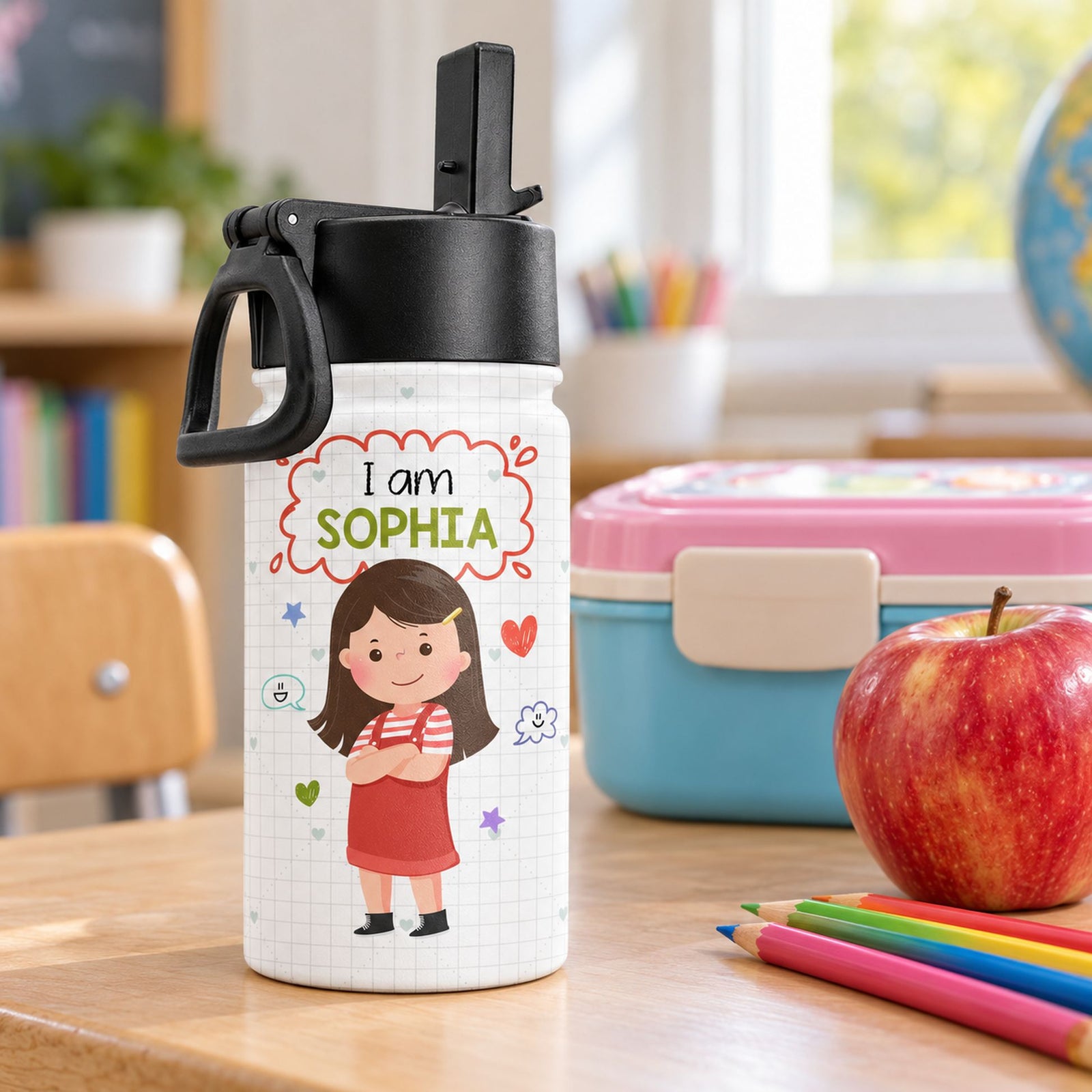 12oz personalized kids stainless steel water bottle next to a lunchbox and apple for size scale