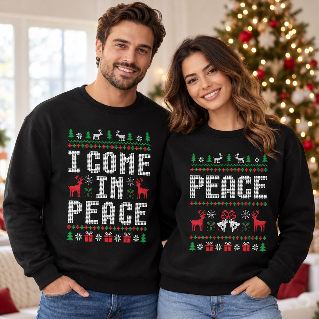 Couple wearing matching black I Come in Peace and Peace ugly Christmas sweatshirts by tree