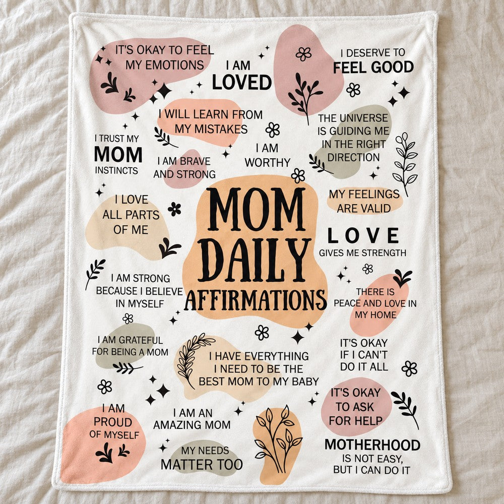 Mom Daily Affirmations fleece blanket spread flat on a neutral linen bed