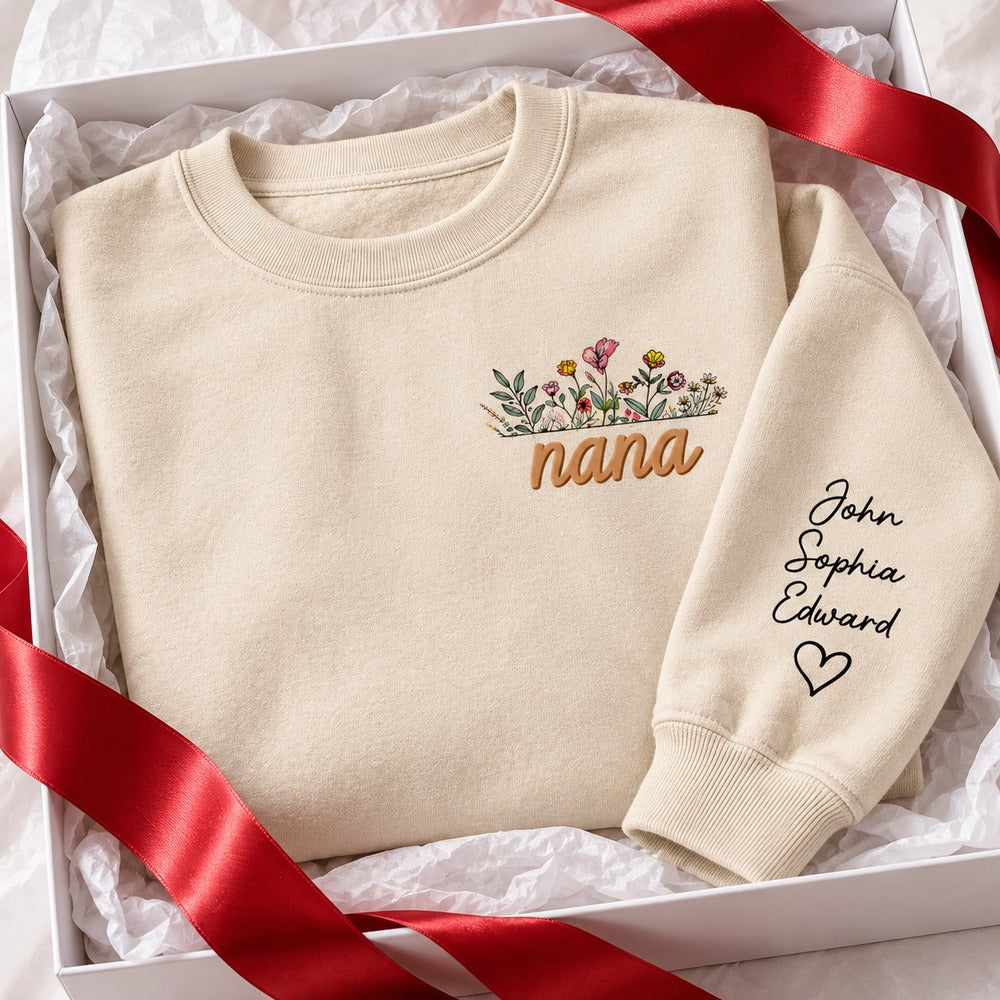 Personalized Nana sweatshirt with sleeve names folded in a holiday gift box