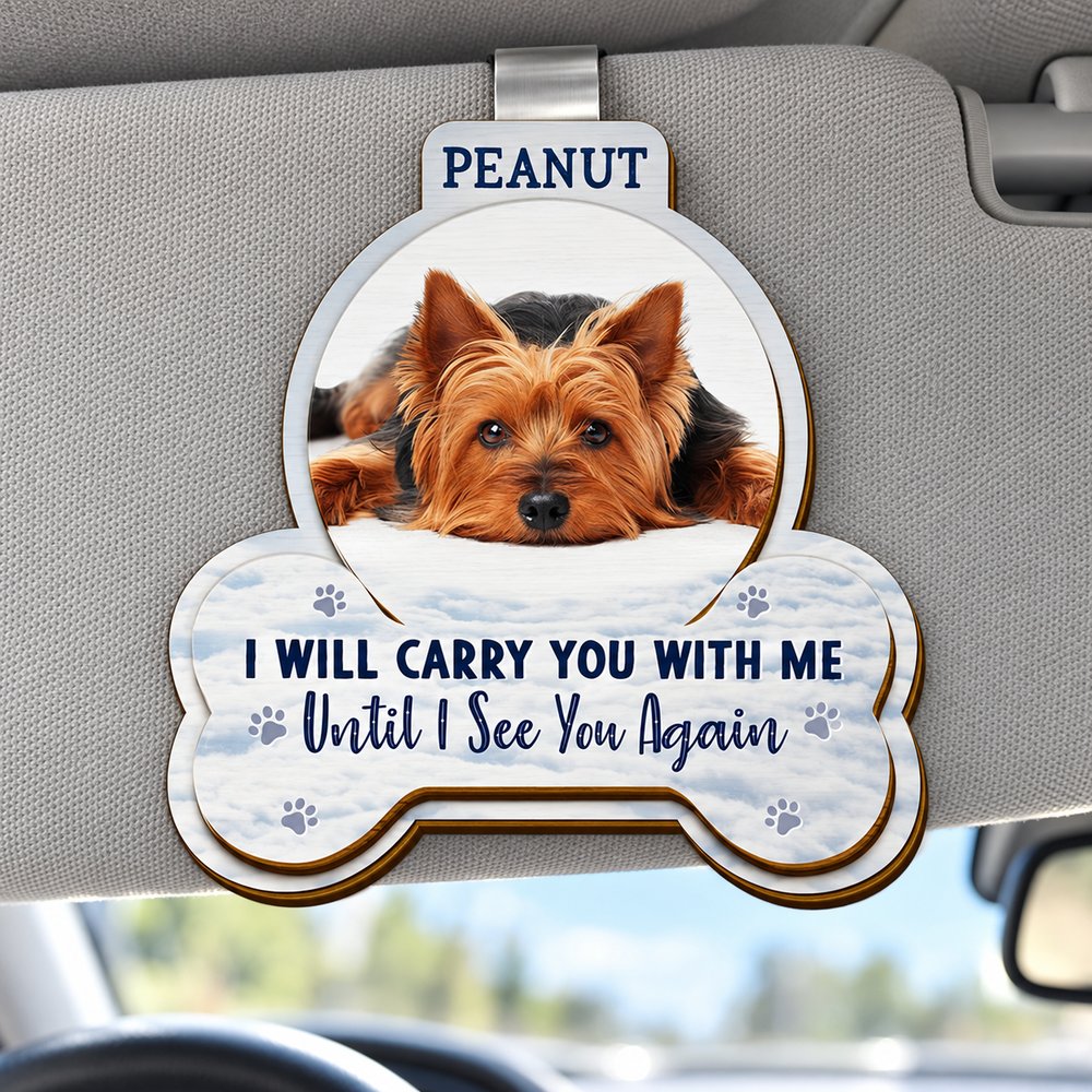 Personalized pet memorial wooden car visor clip attached to a car sun visor in bright daylight