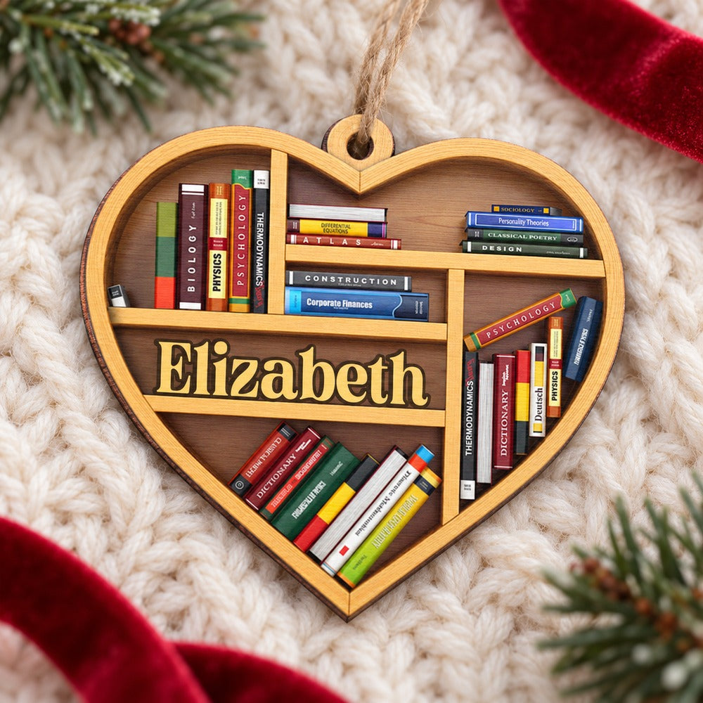 Heart shaped bookshelf wood ornament lying flat on a cream knit blanket with pine greenery