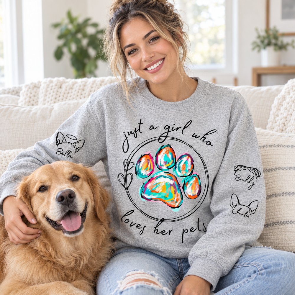 Woman wearing custom dog sleeve printed sweater in heather grey while petting her dog on a sofa