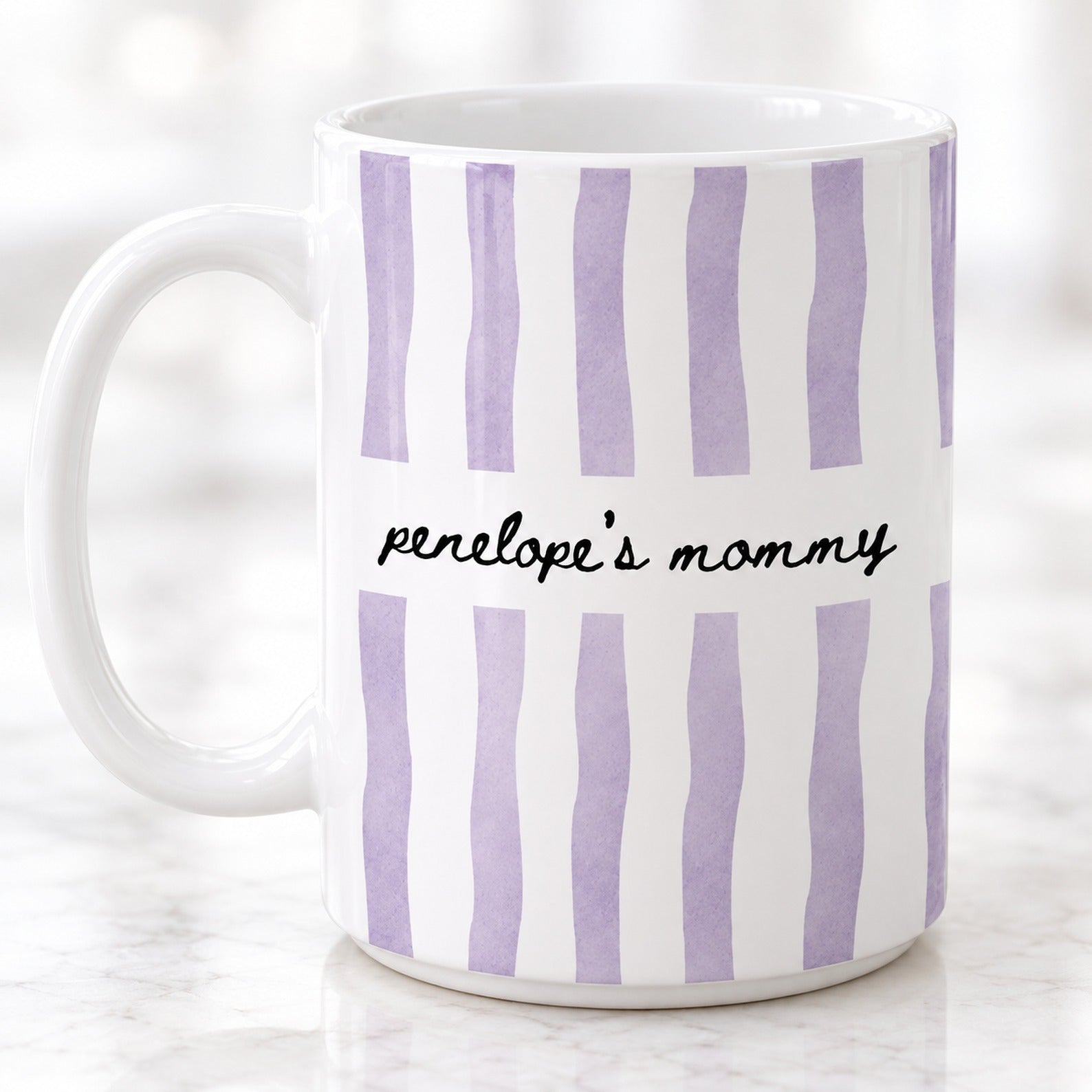 Close-up detail of watercolor stripes and custom cursive lettering on white ceramic mom mug