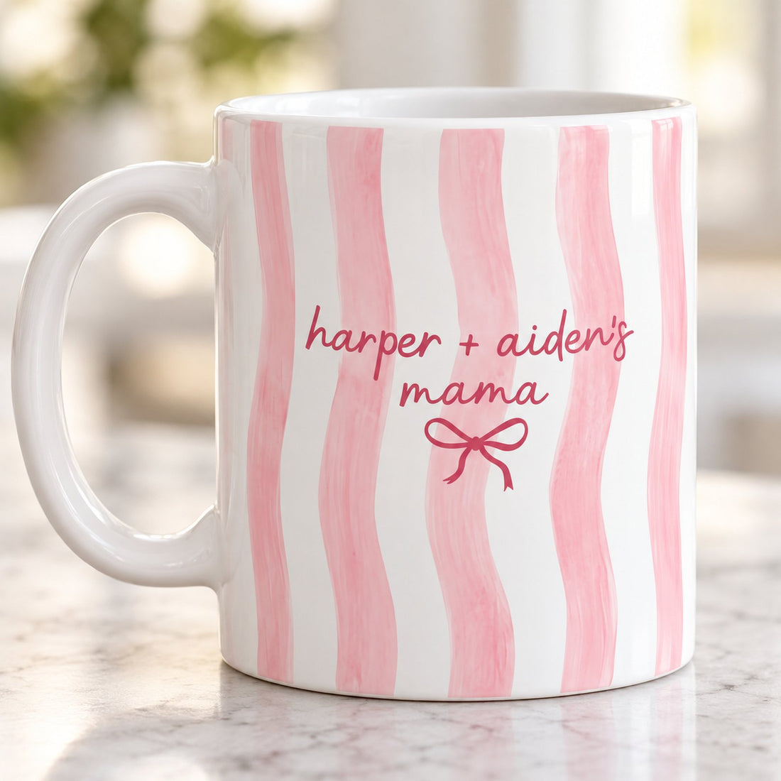 Close-up detail of watercolor pink stripes and custom kids names print on ceramic mug