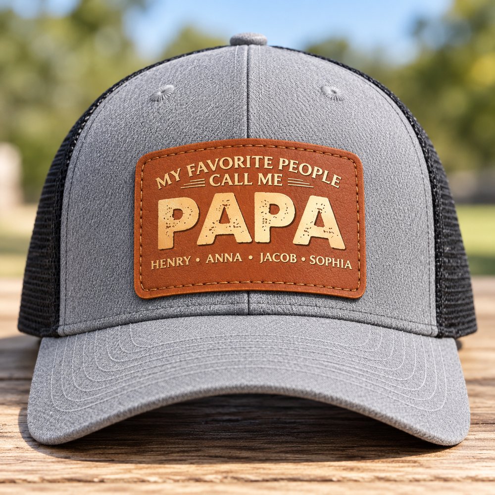 Macro closeup of engraved brown leather patch on personalized Papa trucker hat