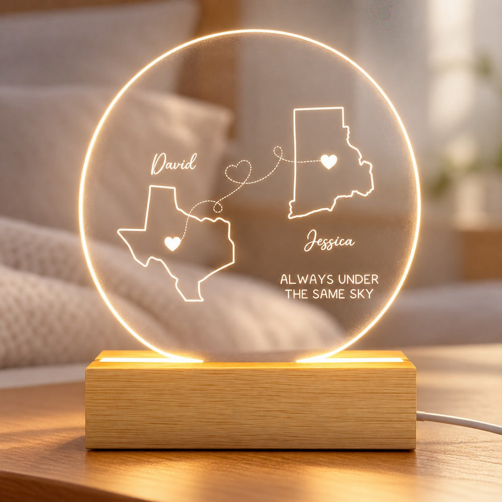 Close-up detail of engraved acrylic state maps and wooden LED base on couple night light
