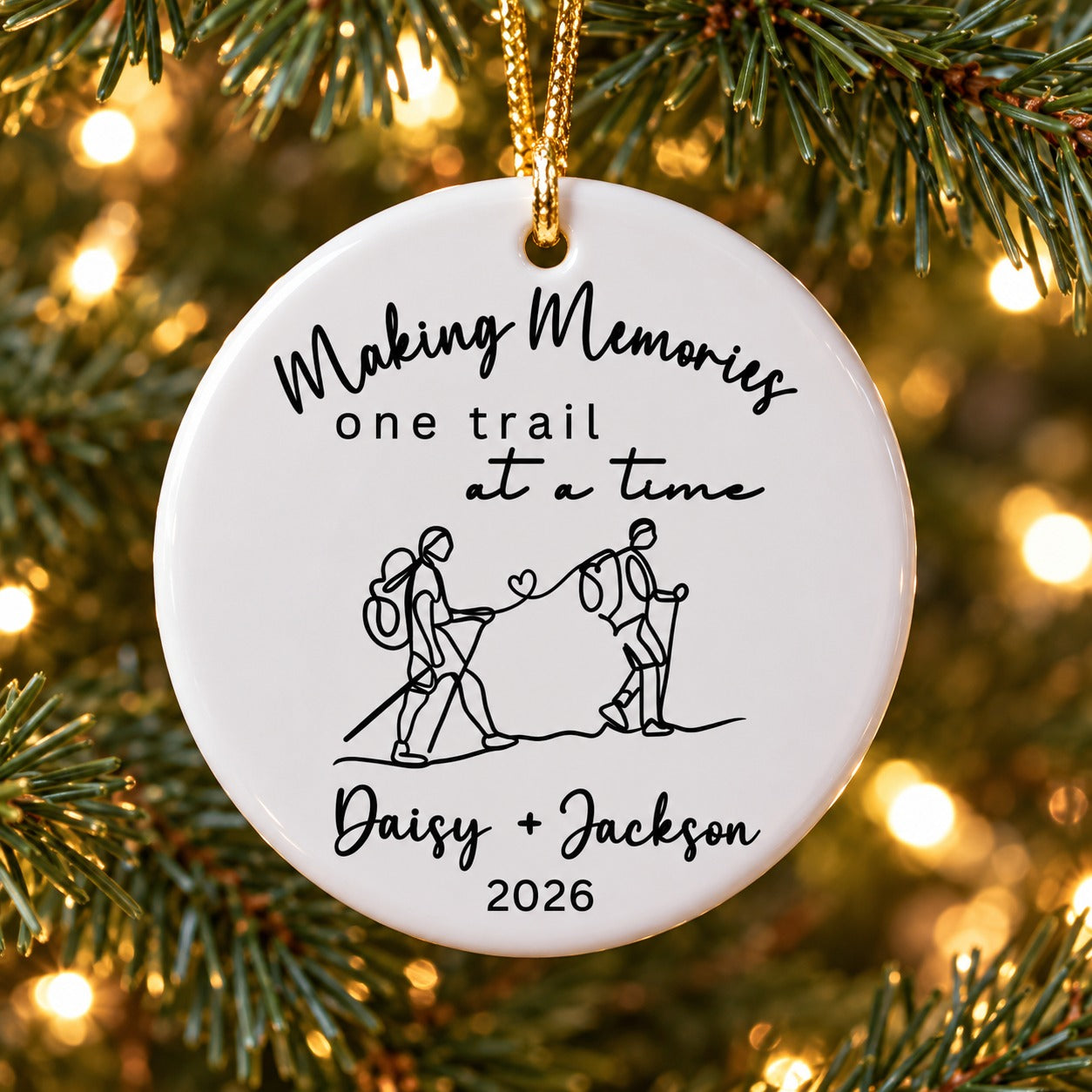 Personalized hiking couple circle ceramic ornament hanging on a Christmas tree branch