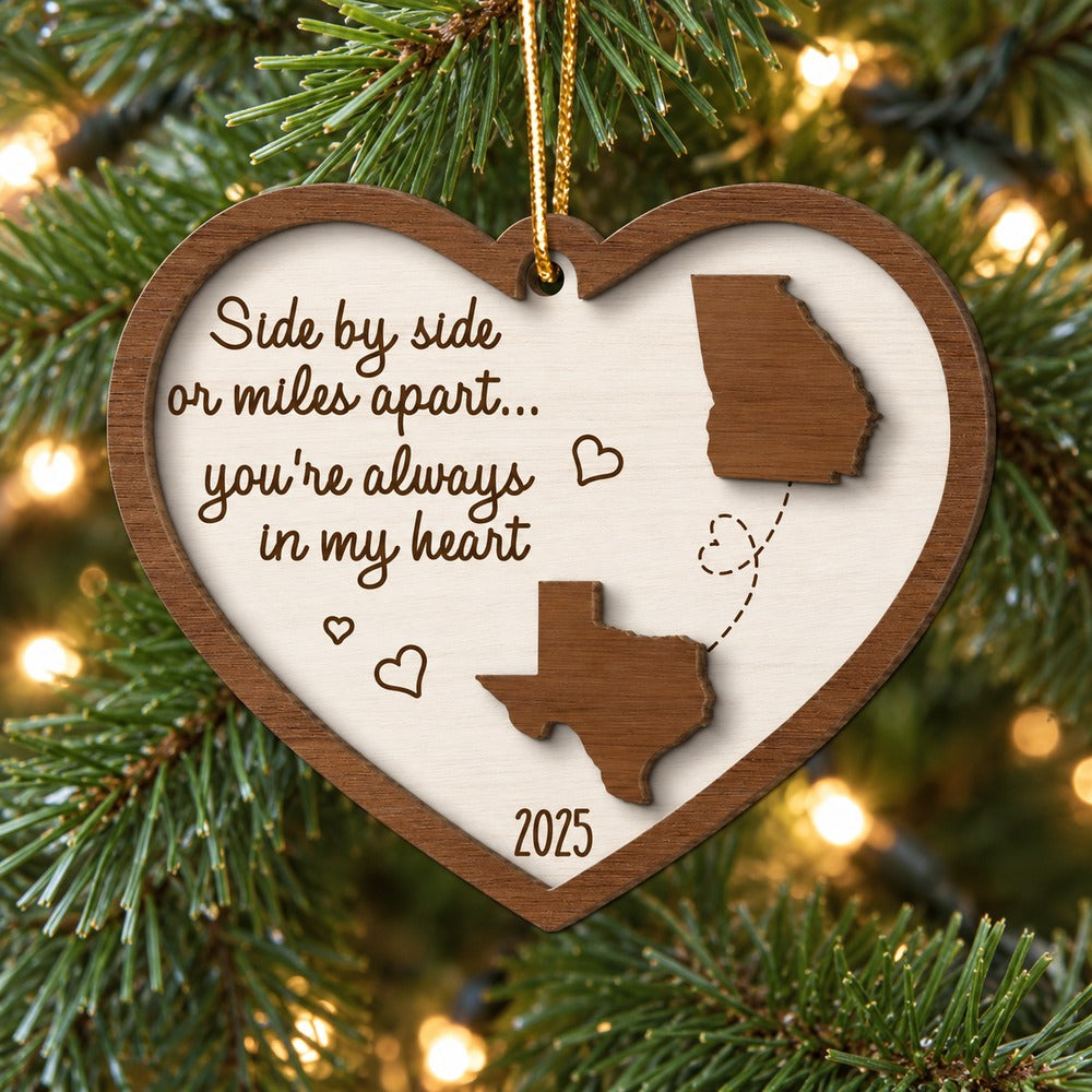 Miles Apart 2-layered wood state map ornament hanging on a Christmas tree branch