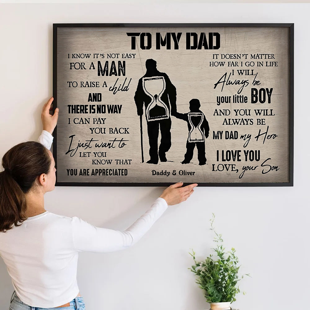 Personalized To My Dad From Son poster, a woman hanging the framed print on a wall