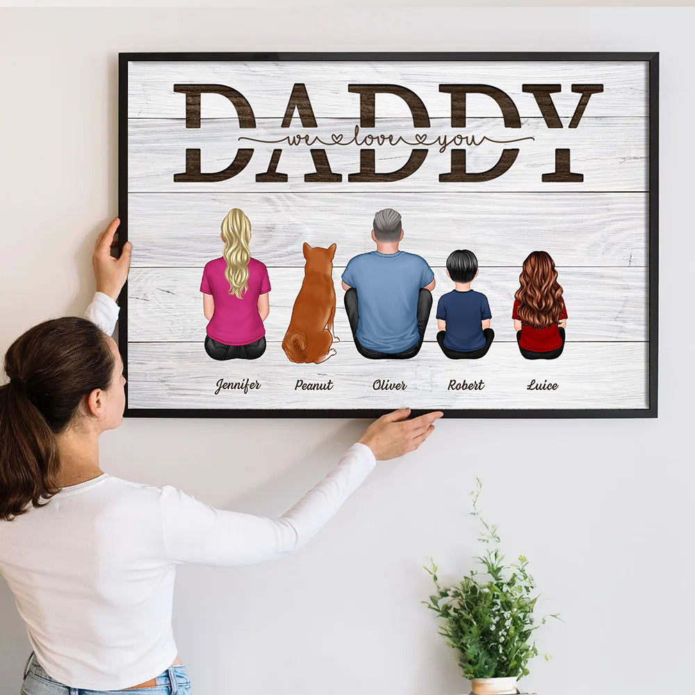 Personalized Daddy We Love You poster, a woman hanging the framed print on a wall