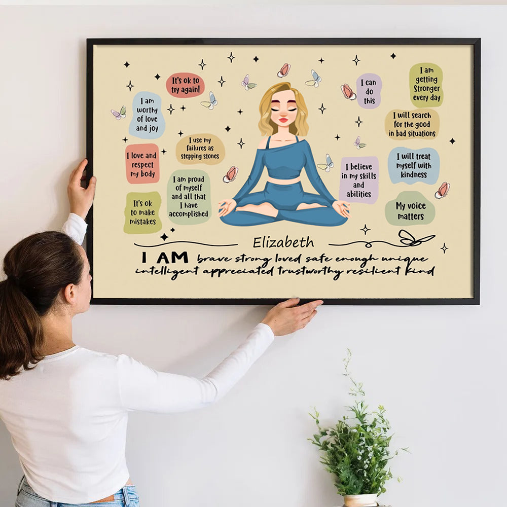 Personalized I Am Brave Strong Loved poster, a woman hanging the framed print on a wall