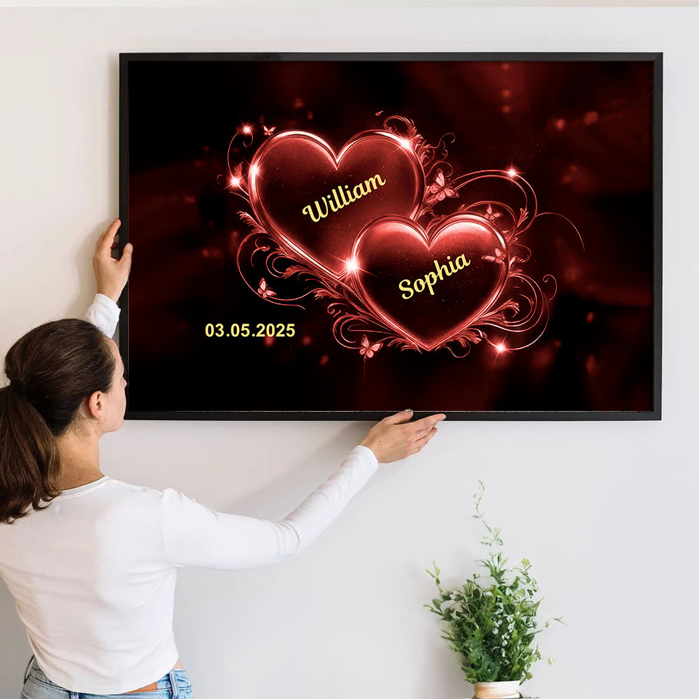 Personalized Romantic Couple Heart canvas print, a woman hanging the framed print on a wall