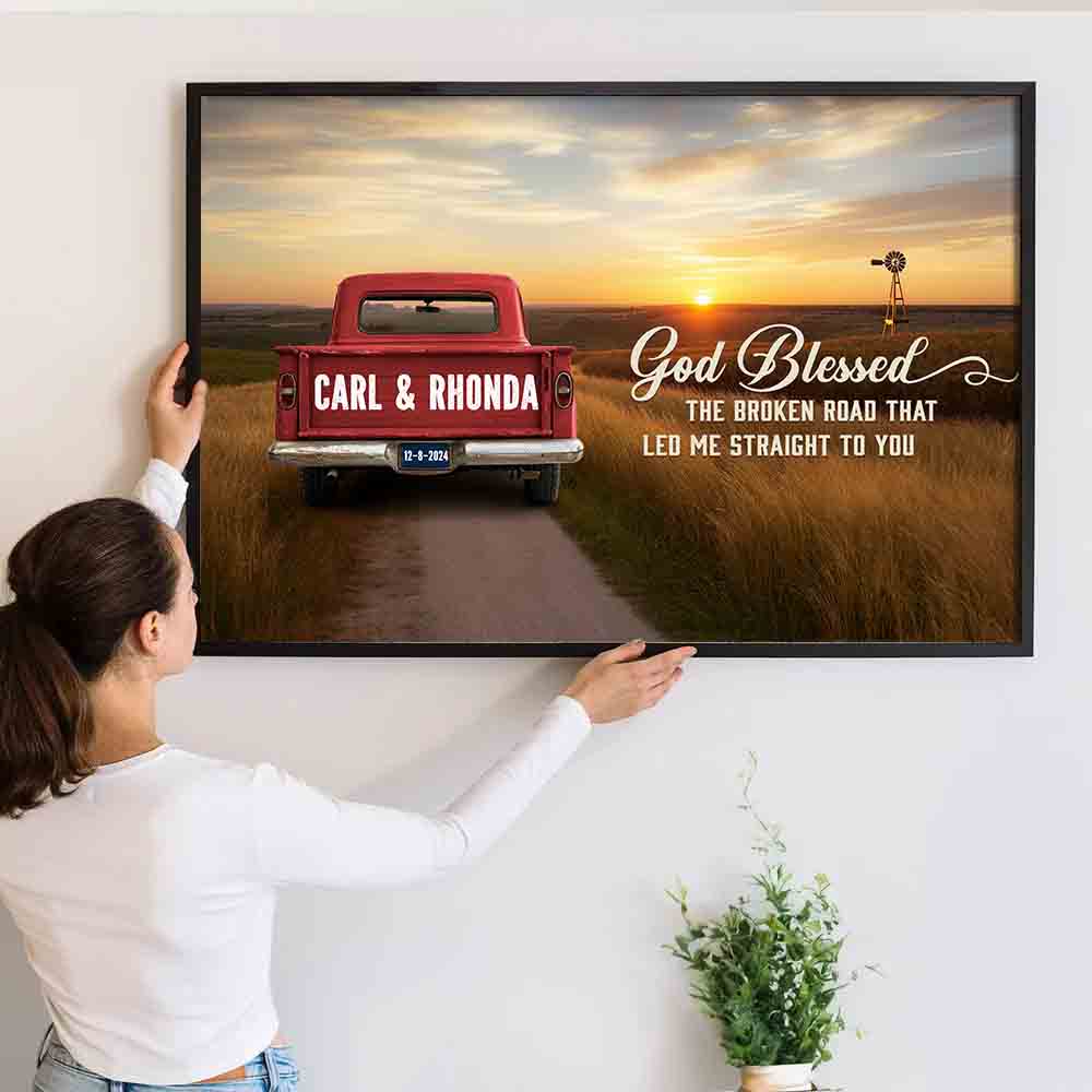 Wife or Husband's Personalized Canvas: "God Blessed The Broken Road" poster, a woman hanging the framed print on a wall