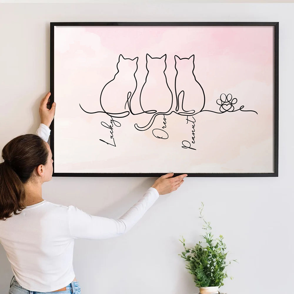 Personalized Adorable Cat Line canvas print, a woman hanging the framed print on a wall