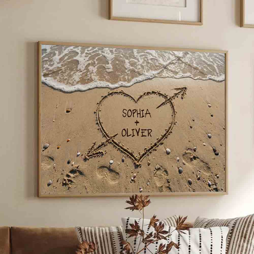 Personalized Couple Names Heart in Sand canvas print, framed in a bright living room