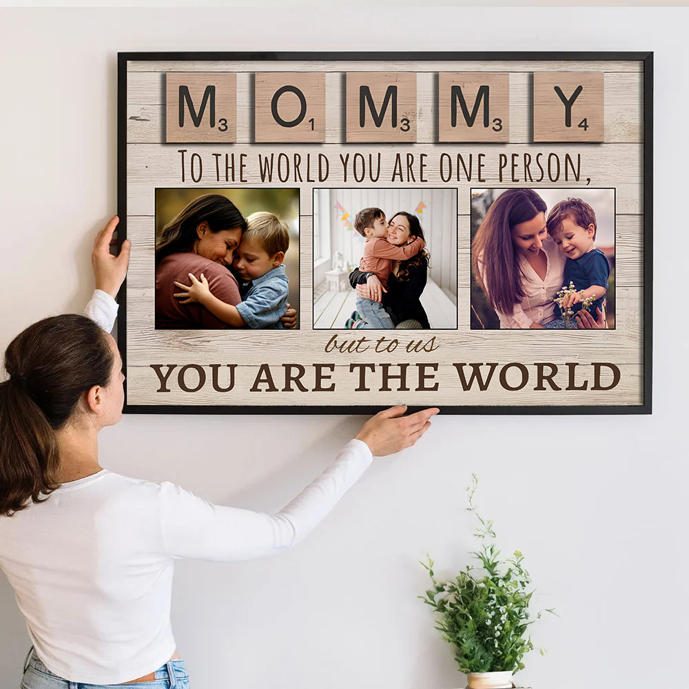 Personalized Mom's Custom Photo Canvas print, a woman hanging the framed print on a wall