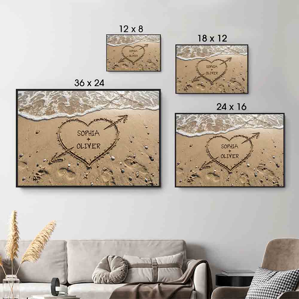 Personalized Couple Names Heart in Sand canvas print, size options shown on a sofa wall