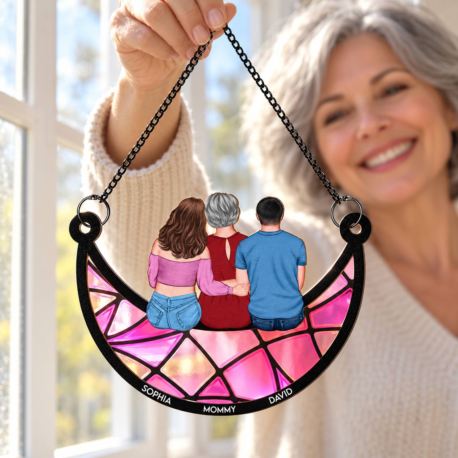 Mother holding her personalized mom and children crescent moon suncatcher gift