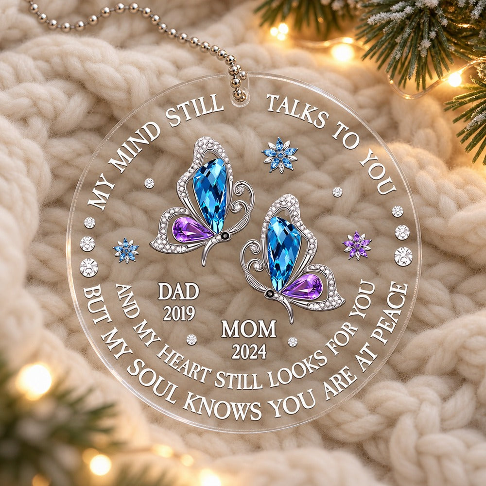 Memorial butterfly acrylic car hanger for loss of mom and dad lying flat on a cozy knit blanket