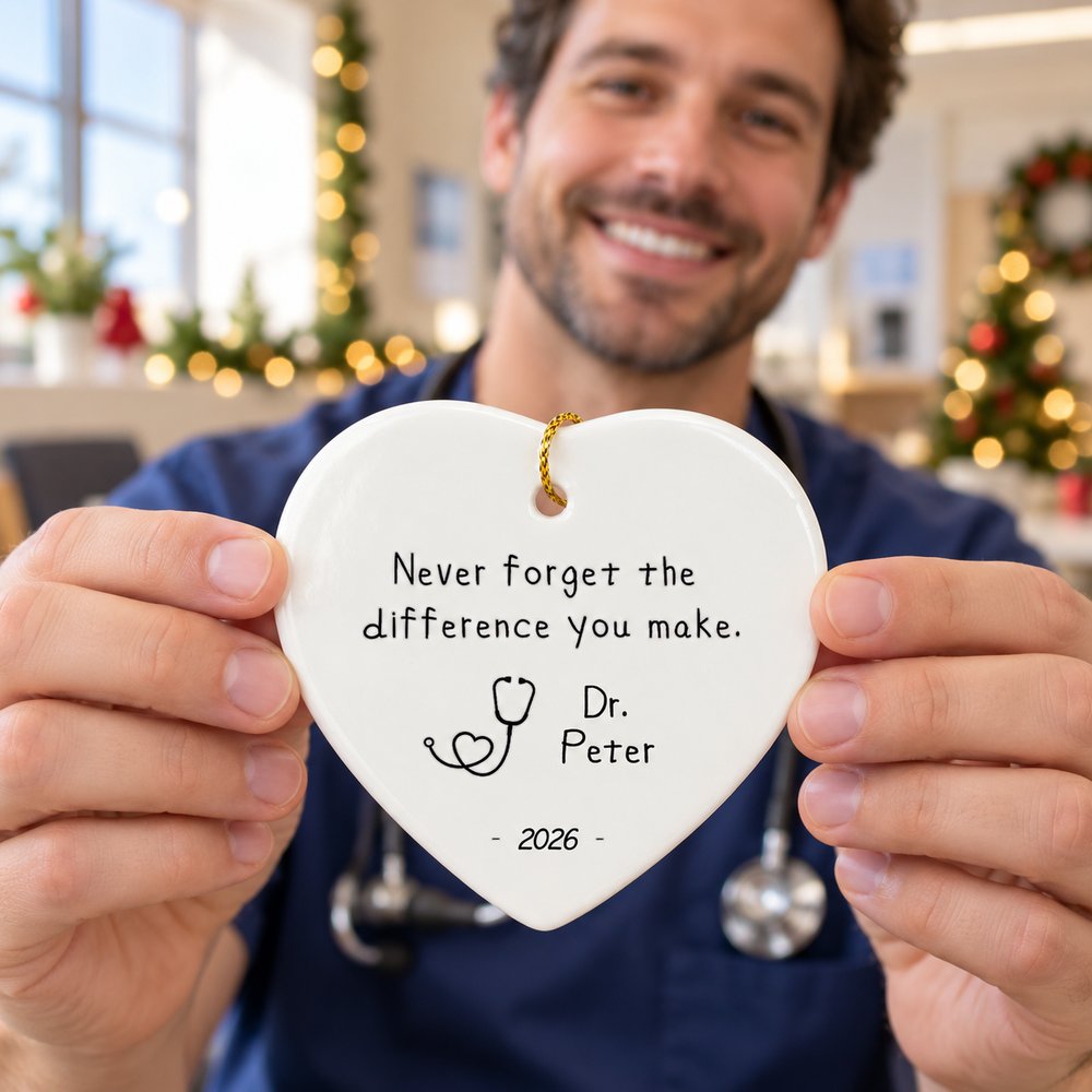 Doctor in scrubs holding the personalized Never Forget The Difference You Make ceramic ornament