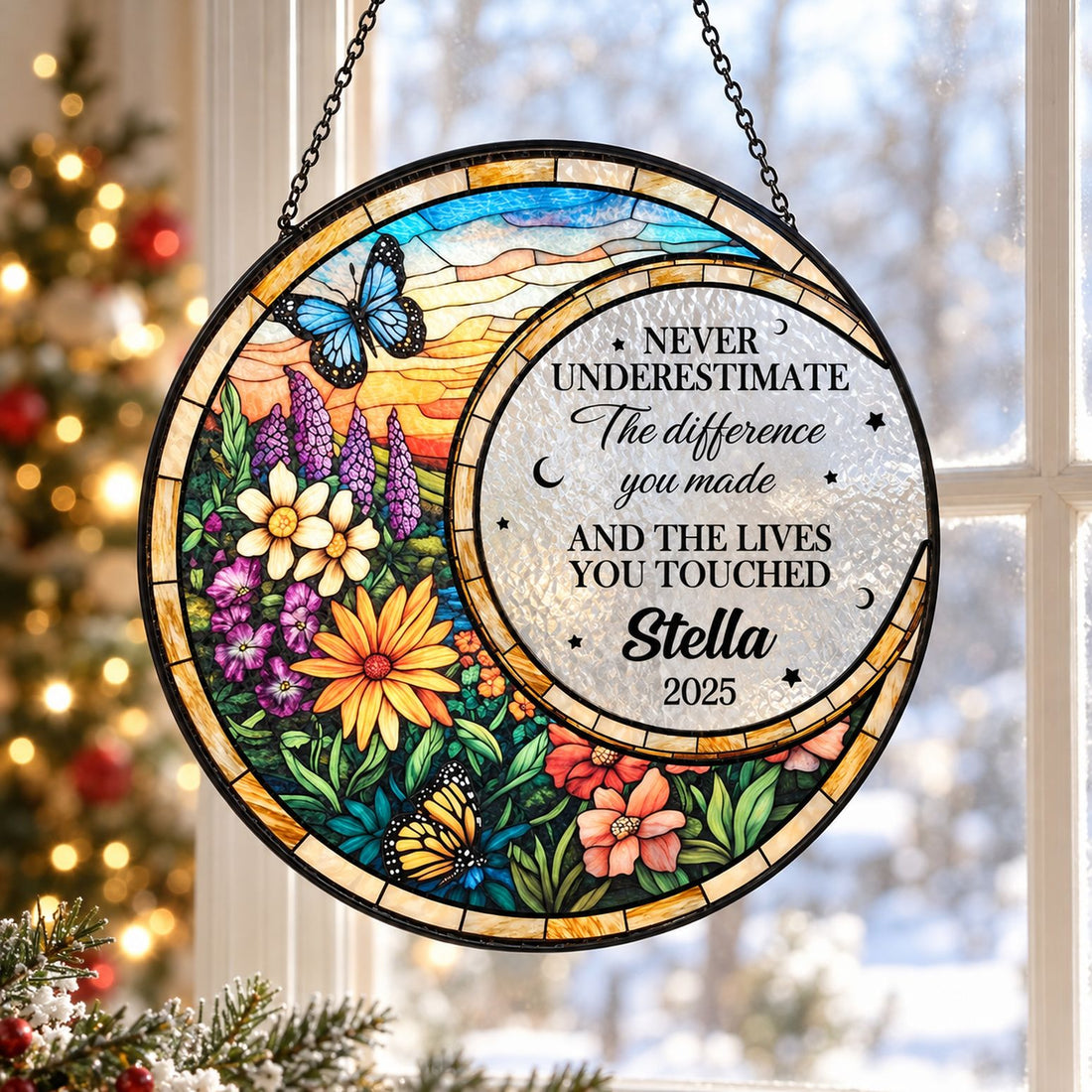 Stained glass window hanging suncatcher displayed near a holiday tree in bright natural light
