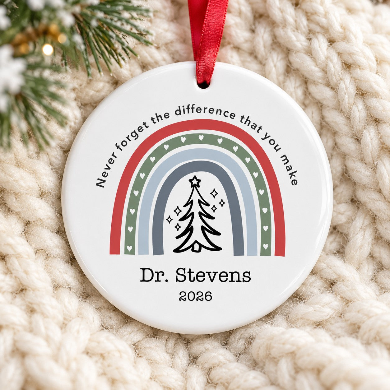 Personalized healthcare circle ceramic ornament Dr. Stevens 2026 lying flat on a cream knit blanket