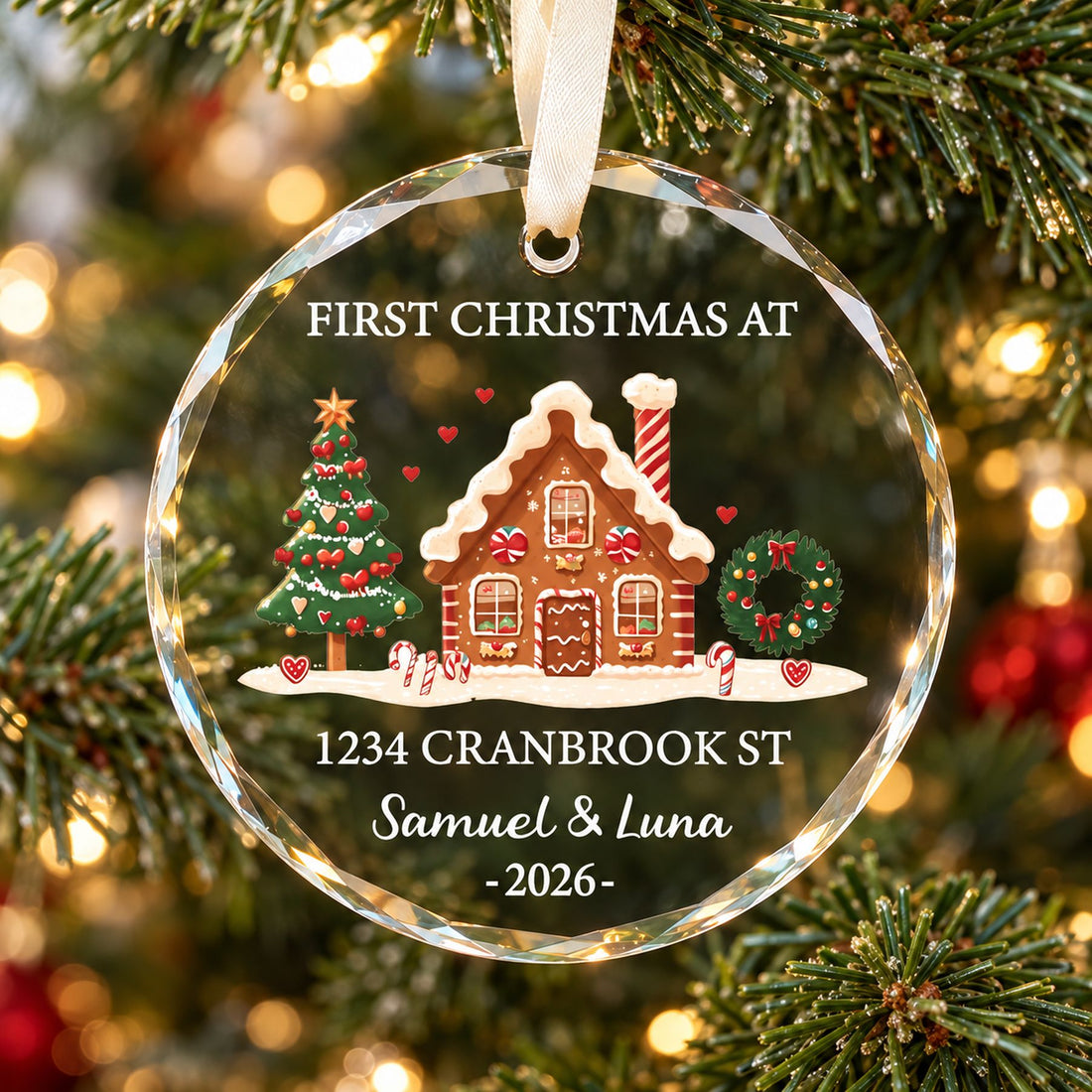 Personalized circle glass First Christmas at New Home ornament hanging on a Christmas tree branch
