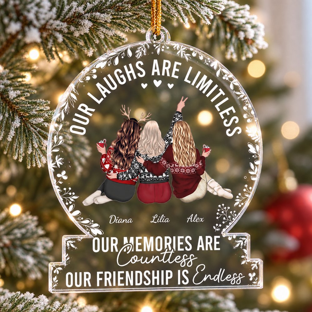 Personalized besties snow-globe acrylic ornament hanging on a Christmas tree branch