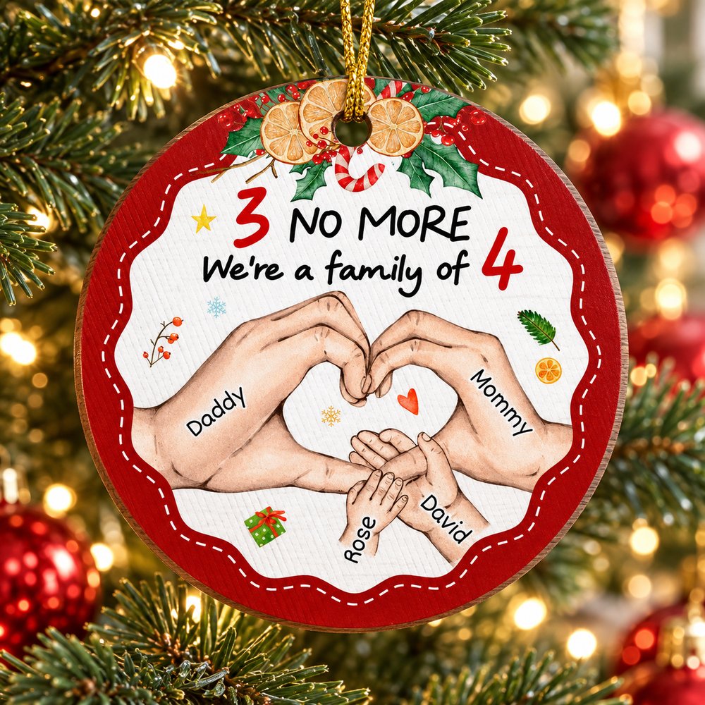 Personalized family of four circle wood ornament hanging on a bright Christmas tree branch