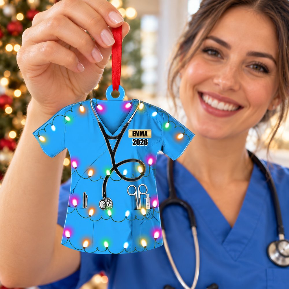 Female nurse holding her personalized Emma 2026 scrub uniform Christmas ornament