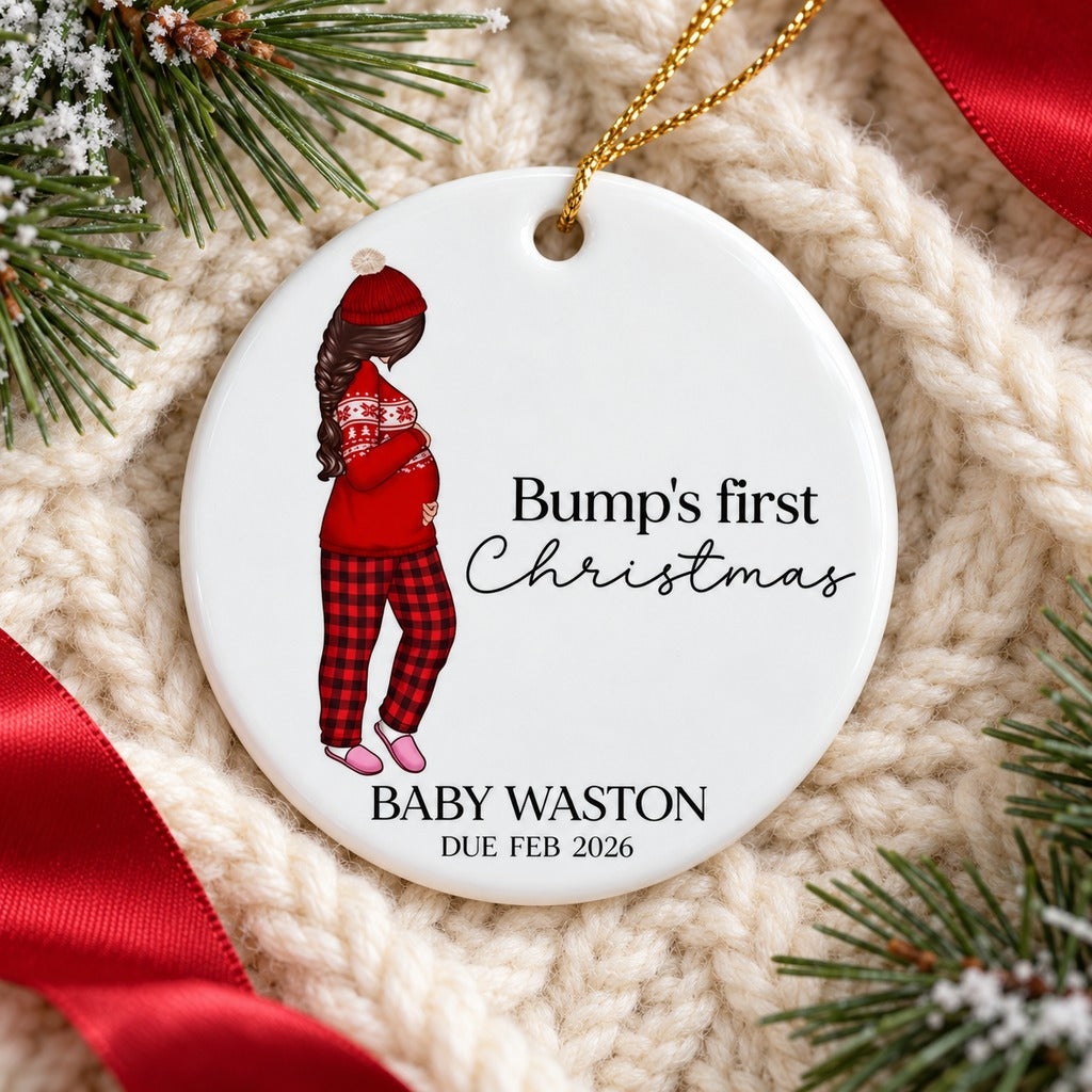Bump's First Christmas ceramic ornament lying flat on a cozy cream knit blanket
