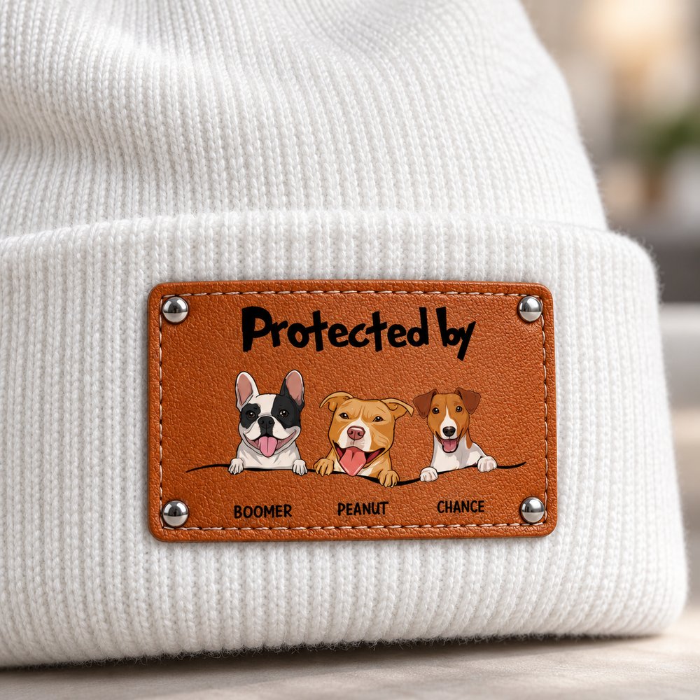 Close-up of leather patch and knit texture on Protected By Dog Beanie