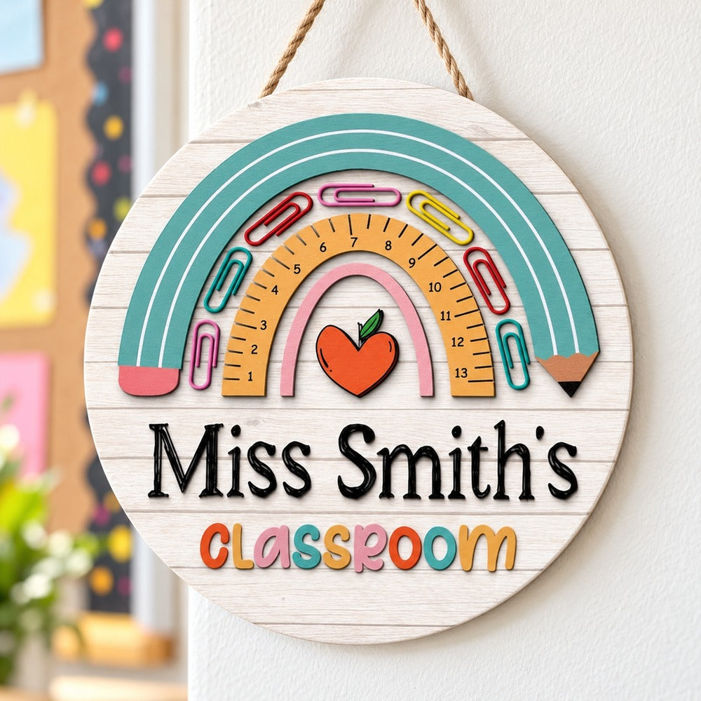 Personalized rainbow teacher round wood sign hanging on a bright classroom wall