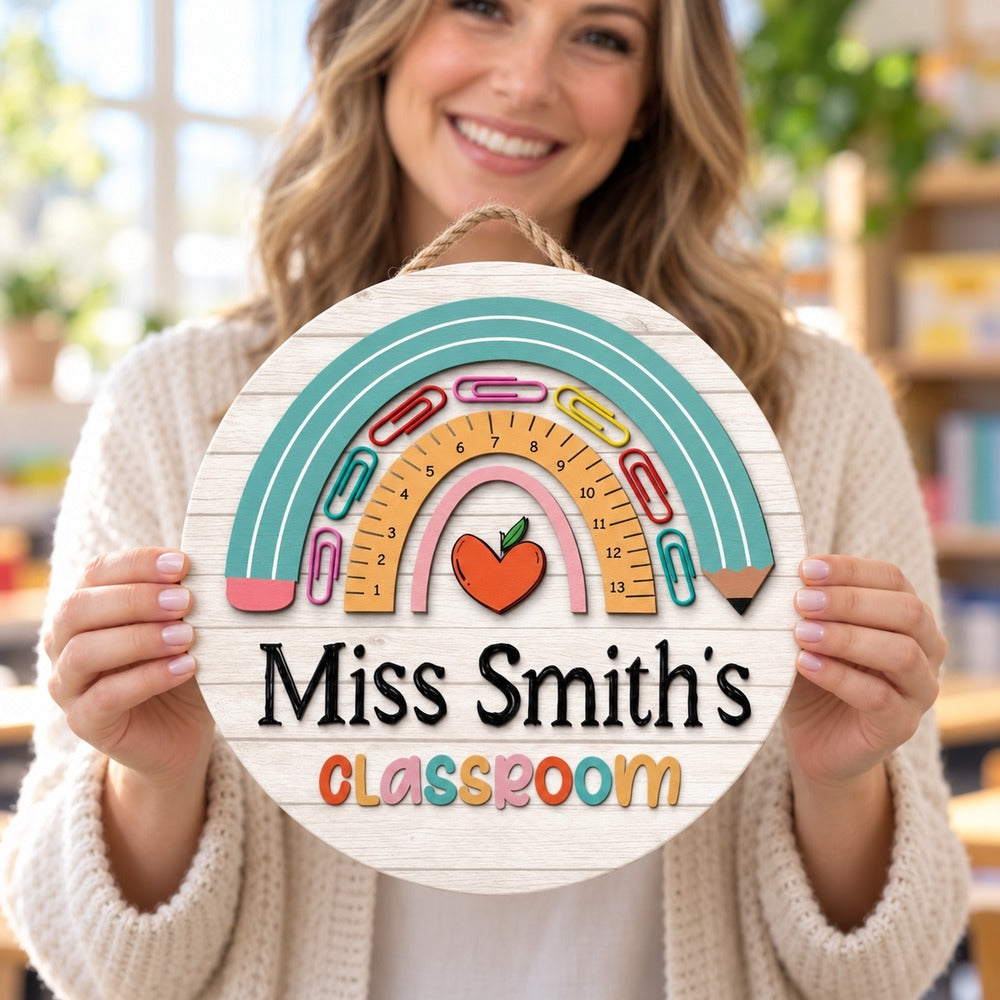Female teacher holding her personalized Miss Smith's Classroom round wood door sign