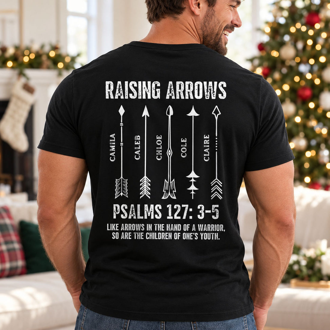 Dad wearing Raising Arrows Christian personalized back printed t-shirt near Christmas tree