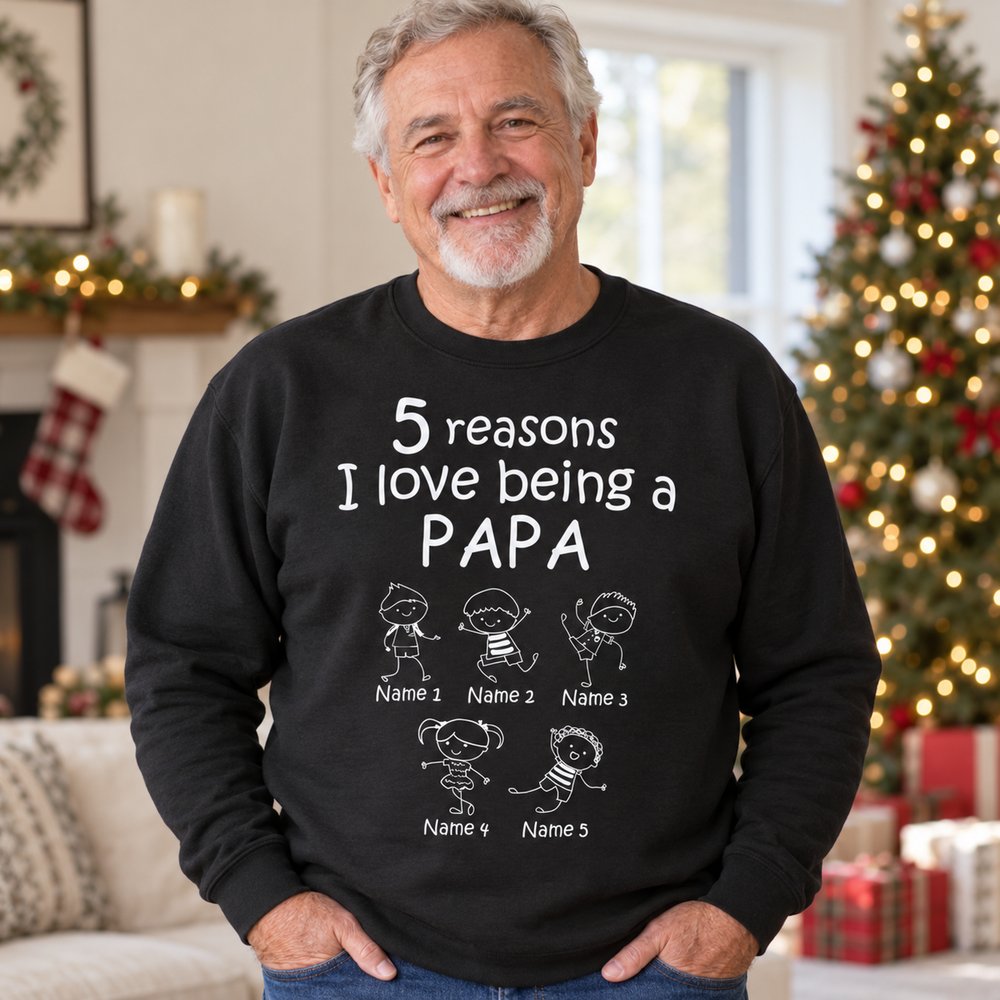Grandpa wearing Personalized Reasons I Love Being A Papa black t-shirt in a bright holiday living room