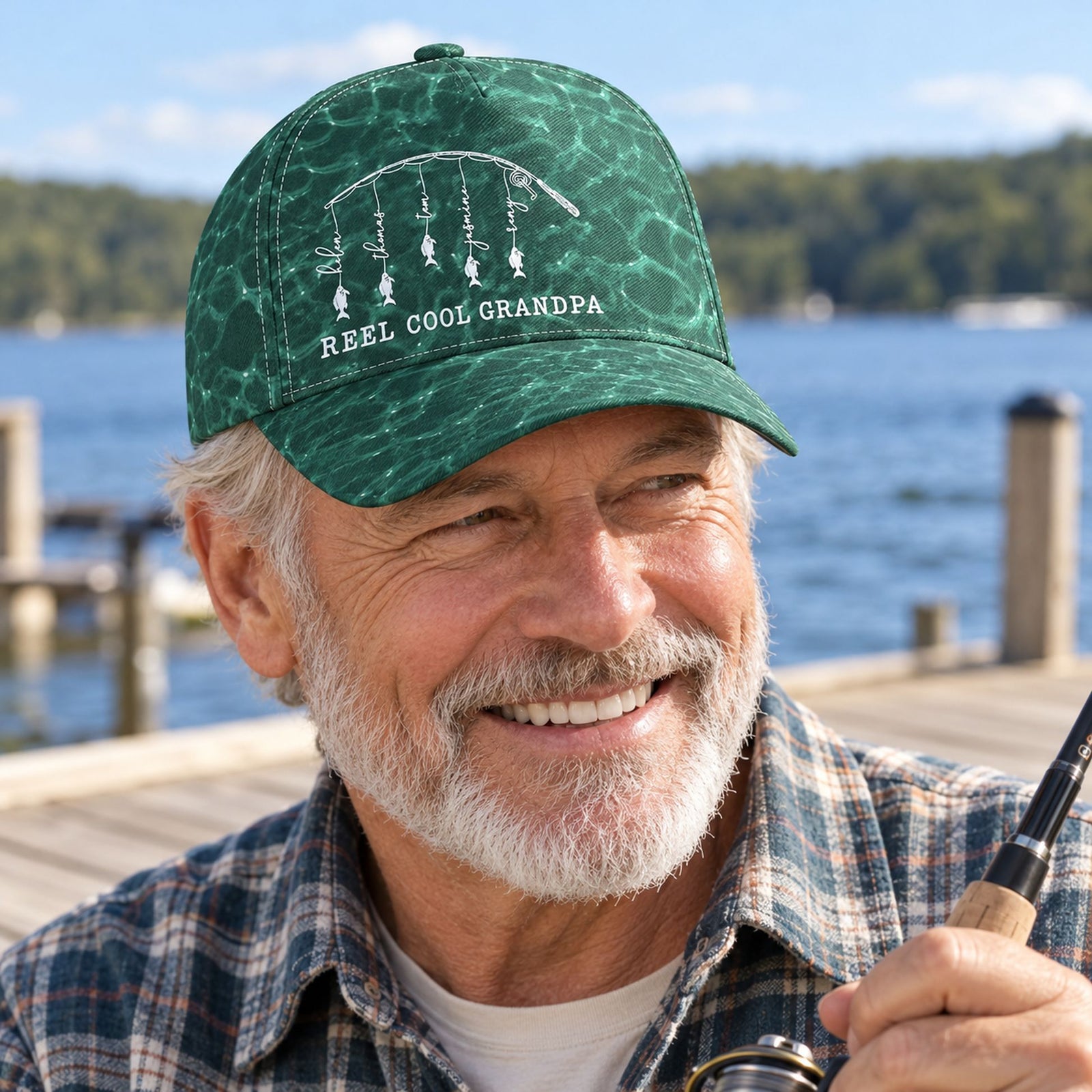 Grandpa wearing Reel Cool Grandpa personalized fishing classic cap on a sunny lakeside dock