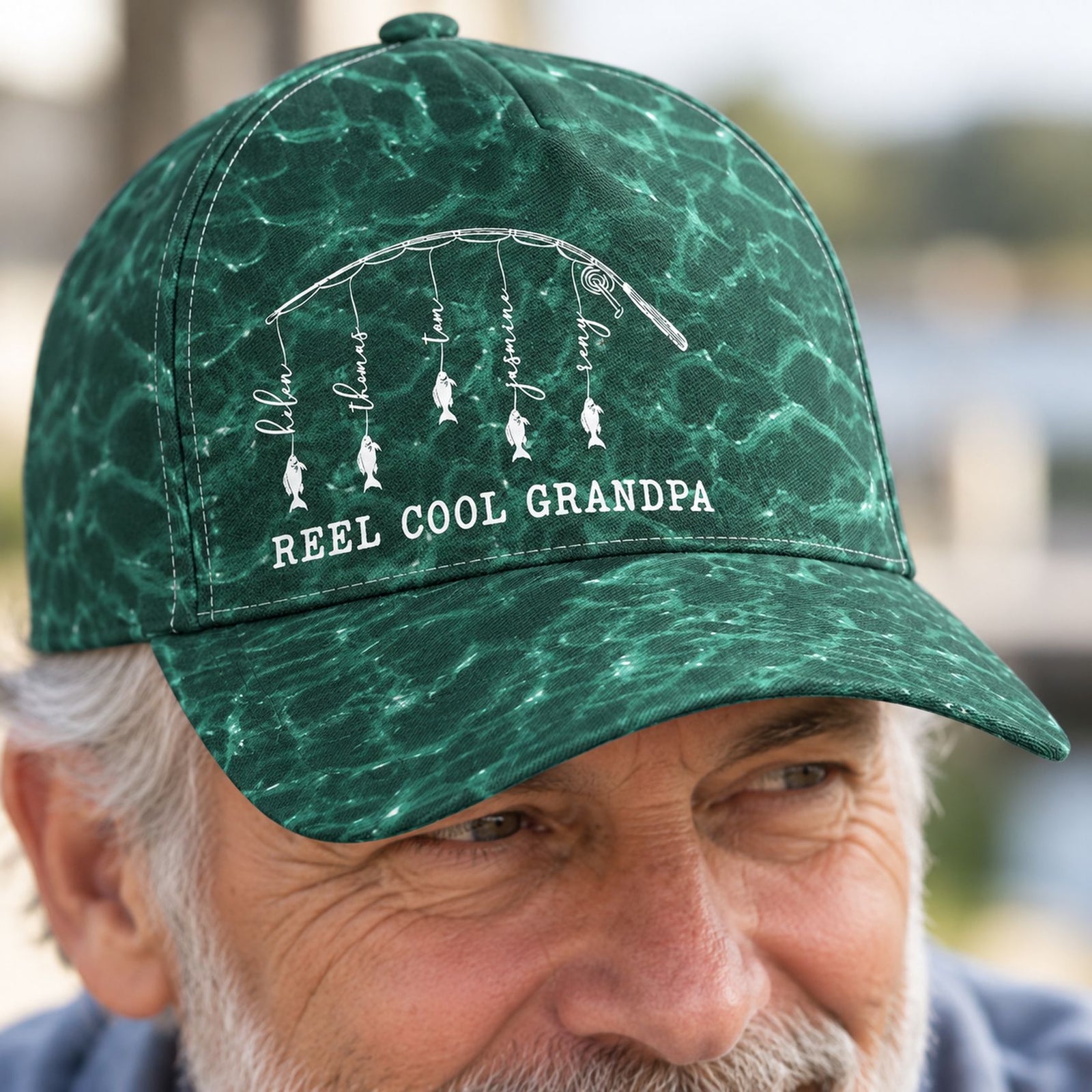Close-up detail of Reel Cool Grandpa classic cap fabric texture and personalized fish print