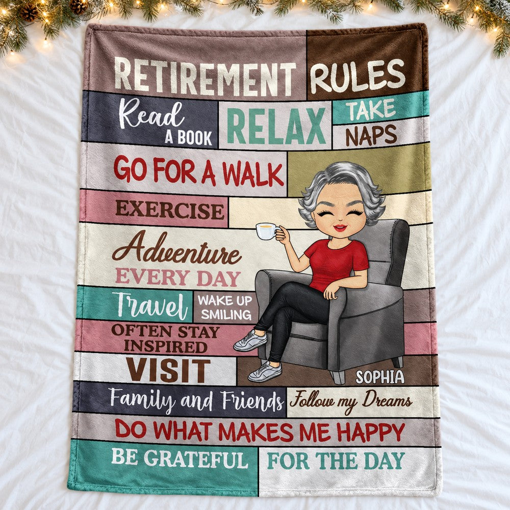 Retirement Rules personalized fleece blanket spread flat on a bed with holiday greenery