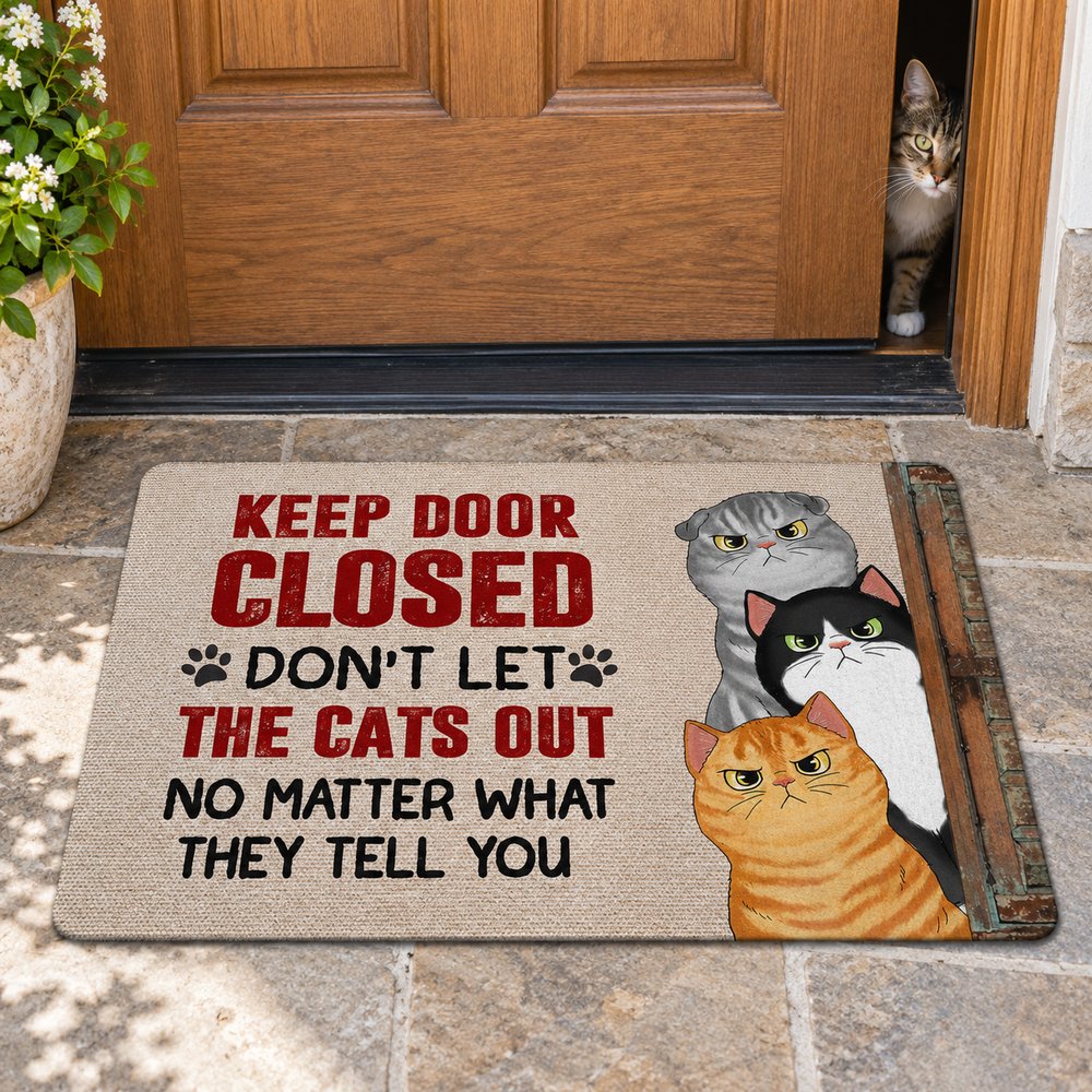 Personalized sassy cats Keep Door Closed doormat lying flat at a wooden front door