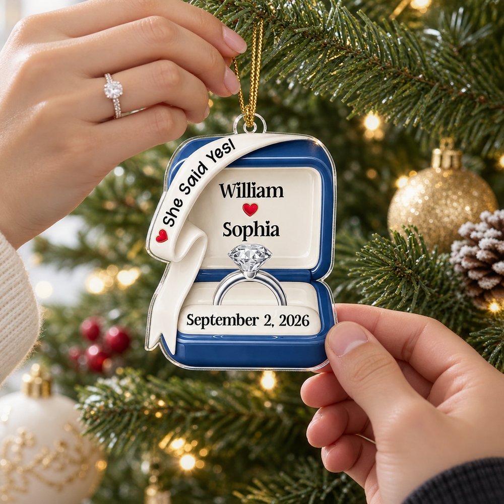 Couple hanging personalized She Said Yes ring box acrylic ornament on Christmas tree