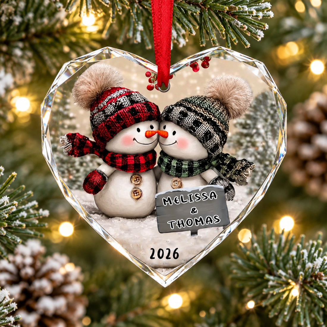 Snowman Couple Personalized Heart Glass Ornament hanging on a Christmas tree branch