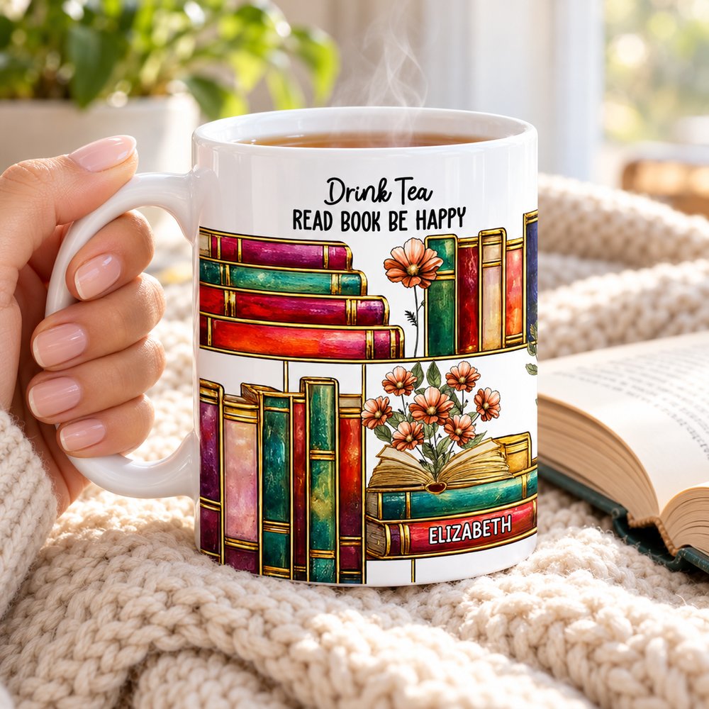 Woman holding personalized stained glass birth flower book lover mug with hot tea and open book