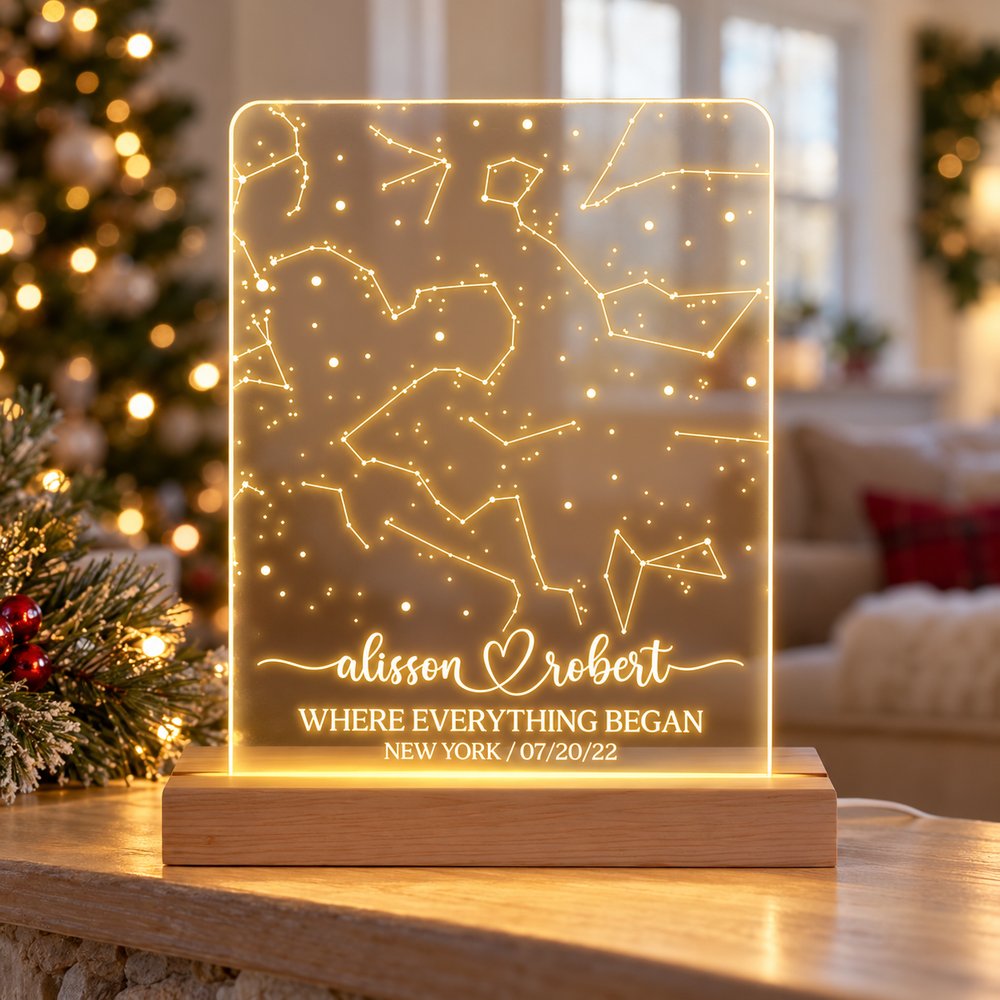 Personalized star map LED night light on a holiday mantel with Christmas tree in background