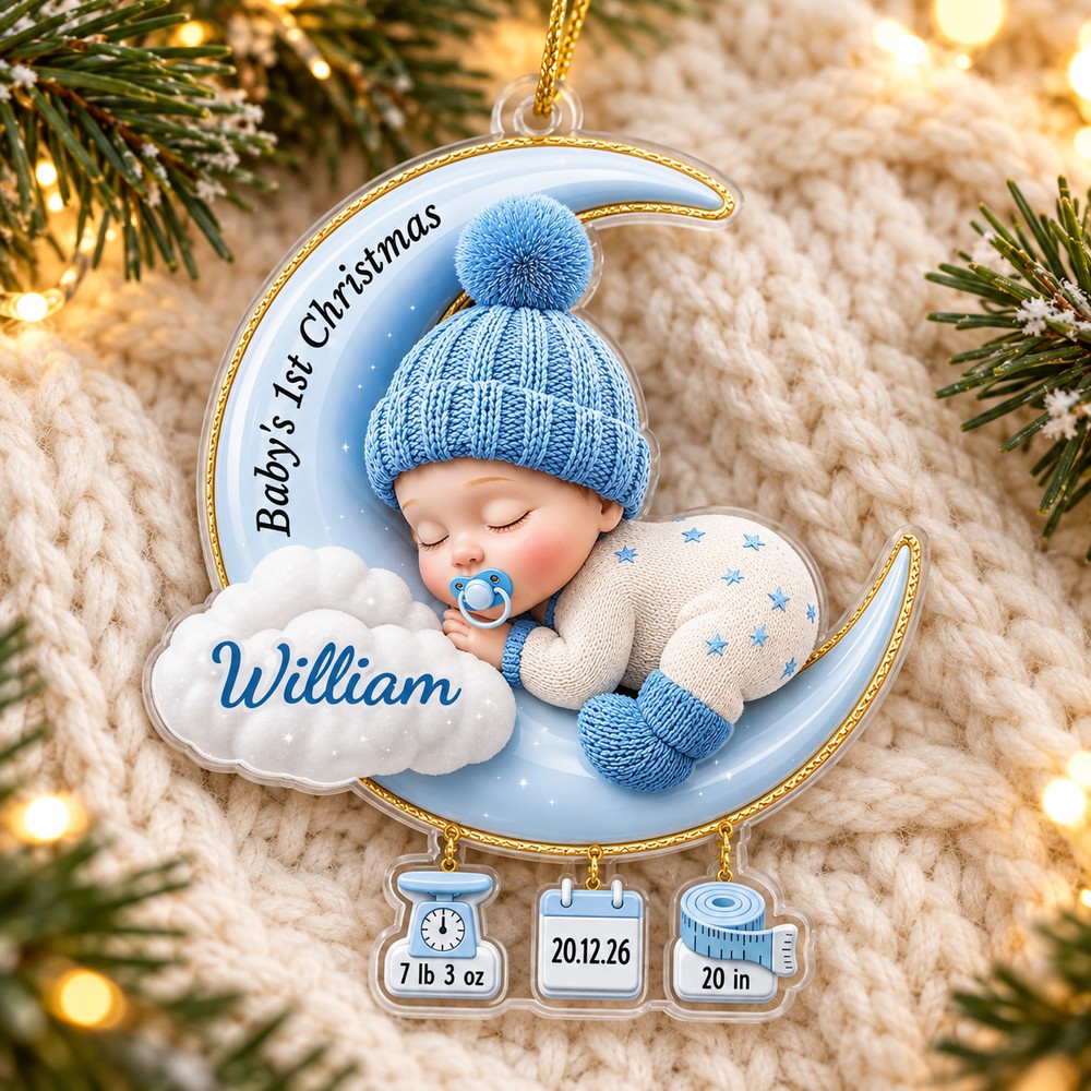 Personalized Baby 1st Christmas acrylic ornament William variant lying flat on cream knit blanket with pine decor
