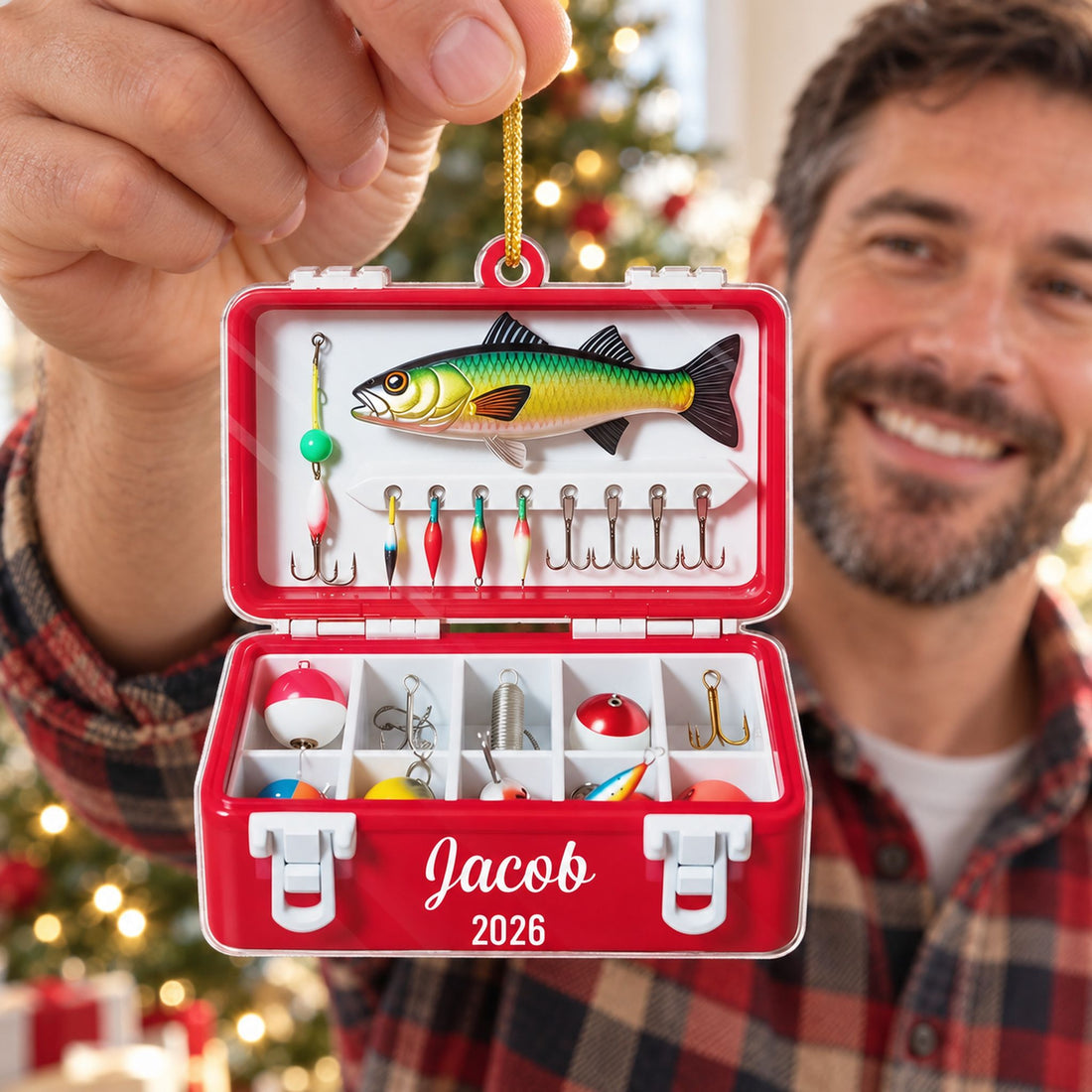 Dad holding personalized fishing tackle box acrylic ornament near Christmas tree
