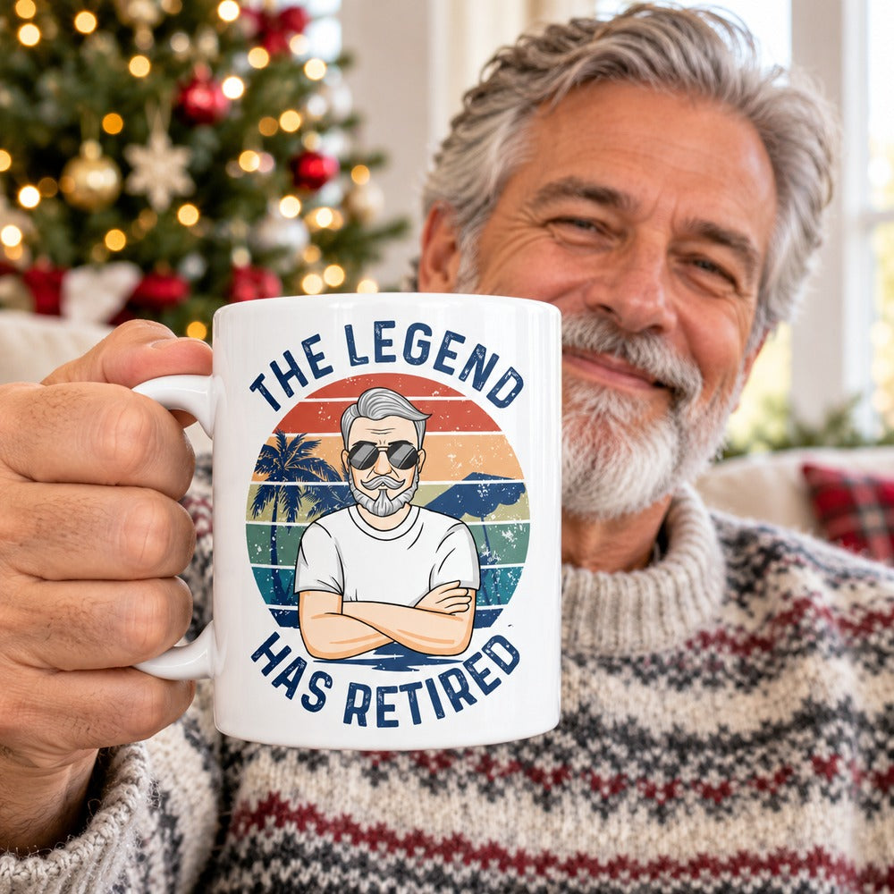 Retired man holding The Legend Has Retired personalized ceramic mug in a festive room