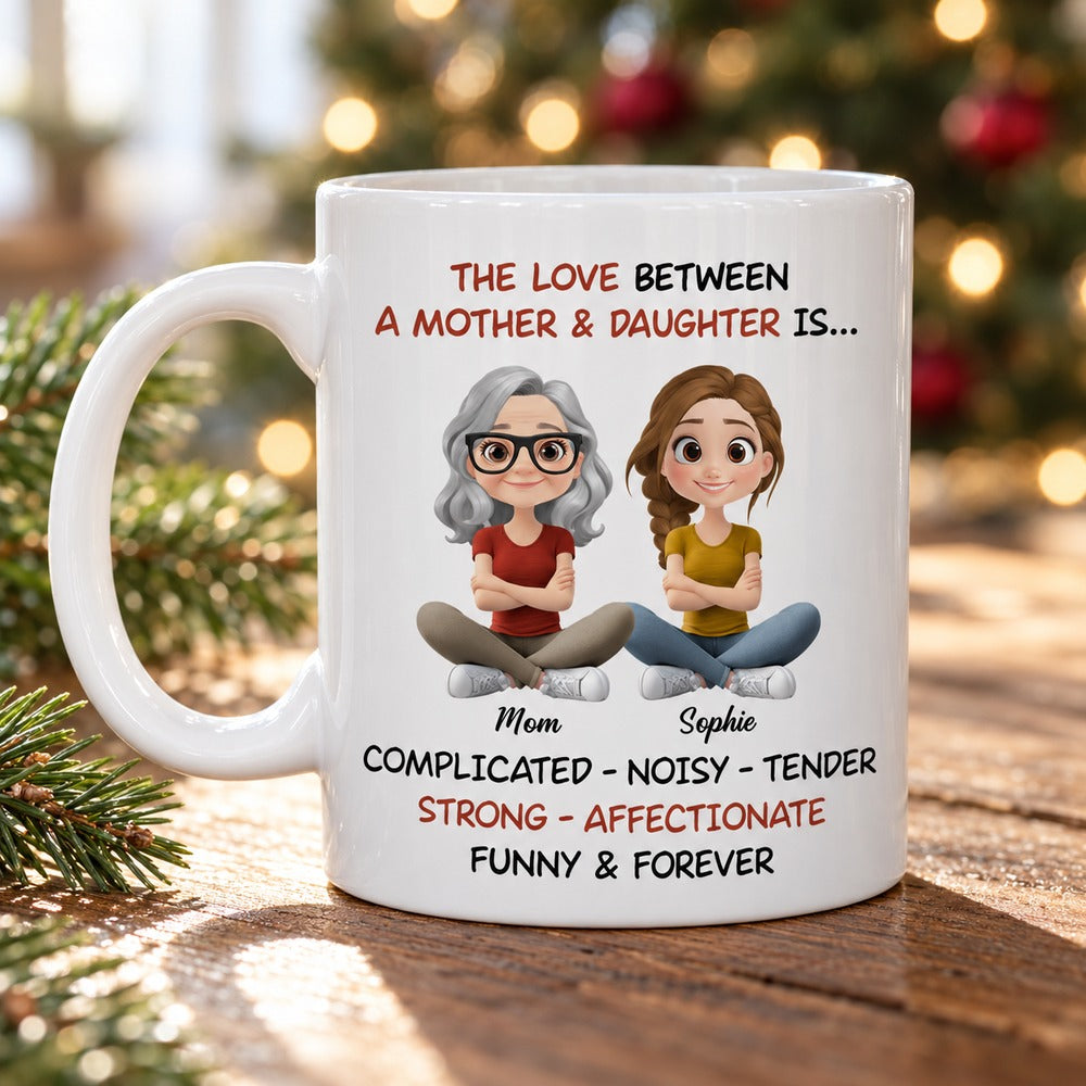 Personalized mother and daughter ceramic mug on a table with soft Christmas decor