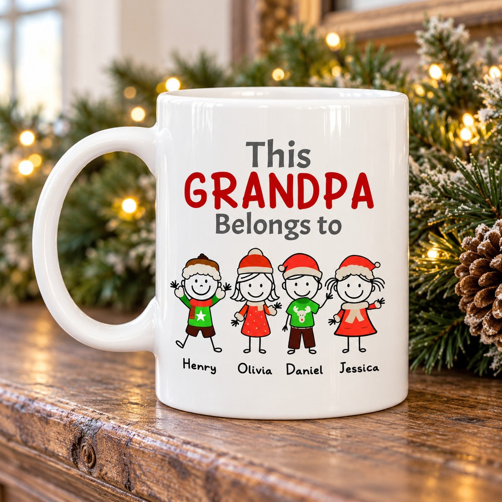 This Grandpa Belongs To personalized white ceramic mug on a Christmas mantel with pine garland